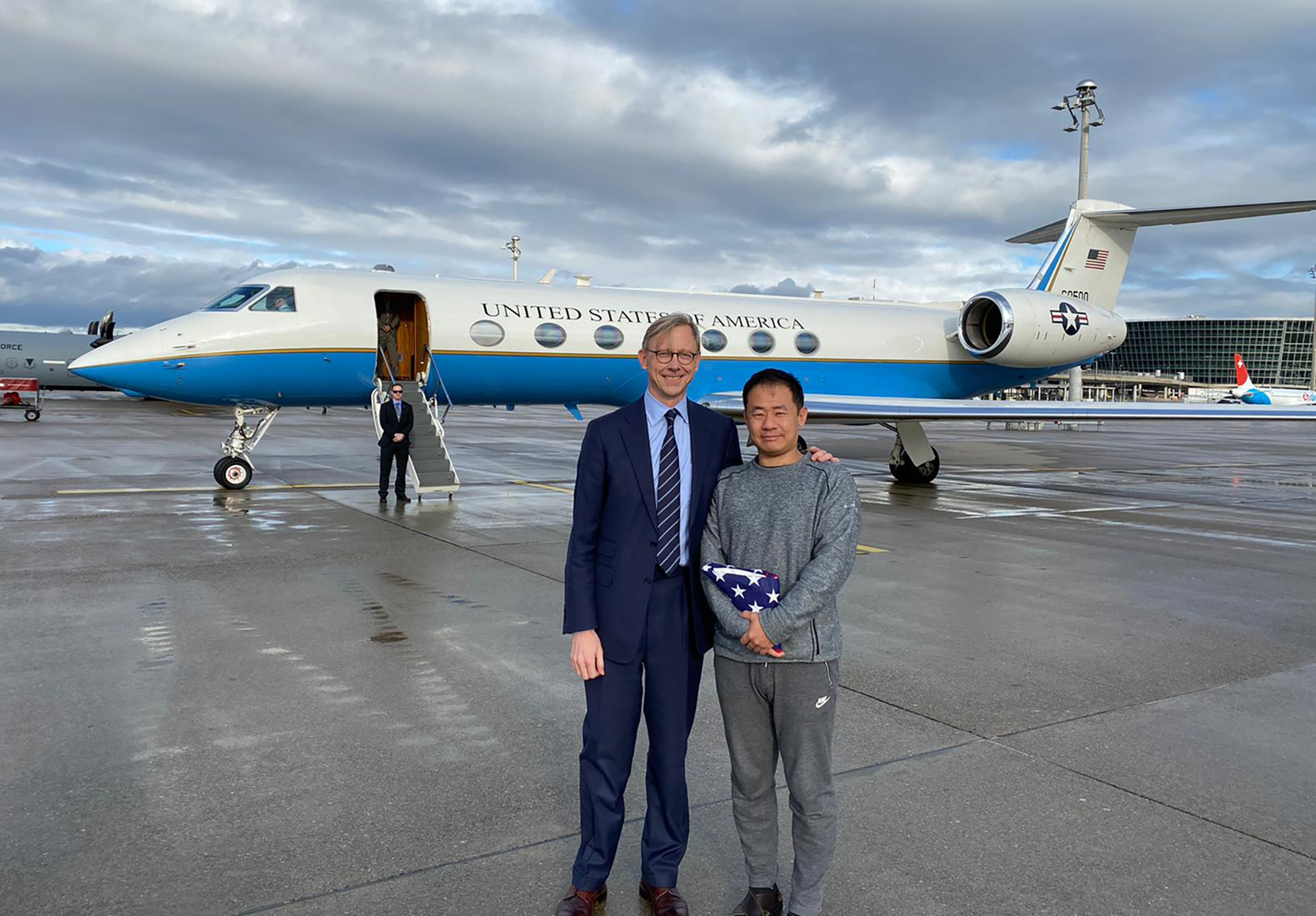 PHOTO: This photo provided by the U.S. State Department, U.S. special representative for Iran, Brian Hook stands with Xiyue Wang in Zurich, Switzerland on Saturday, Dec. 7, 2019.