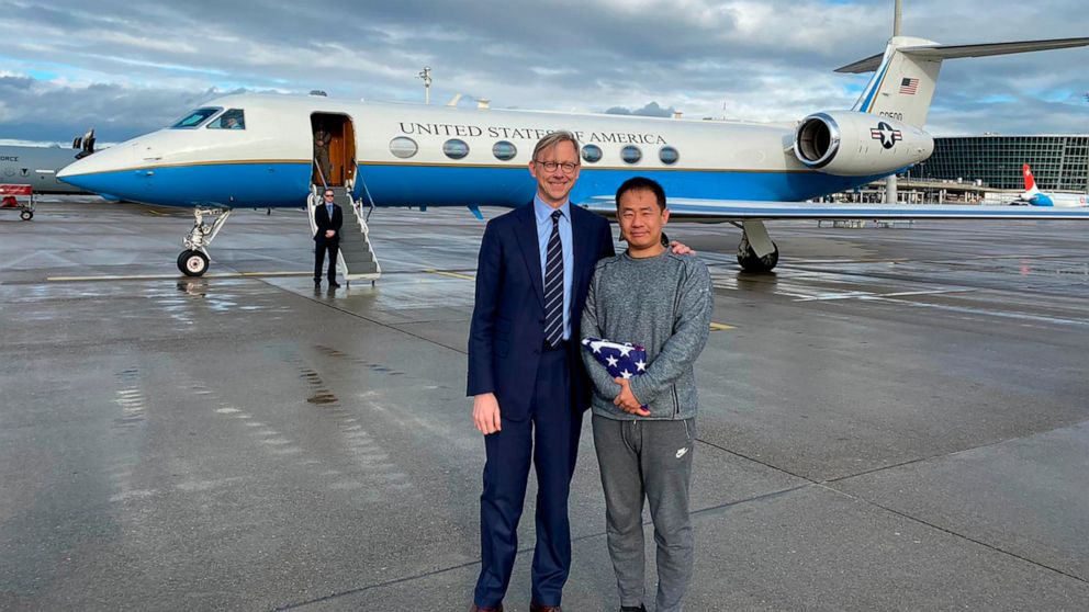 PHOTO: This photo provided by the U.S. State Department, U.S. special representative for Iran, Brian Hook stands with Xiyue Wang in Zurich, Switzerland on Saturday, Dec. 7, 2019.