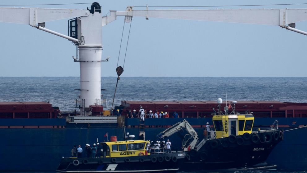 FILE - Russian, Ukrainian, Turkish and U.N. officials arrive to the cargo ship Razoni for inspection while it is anchored at the entrance of the Bosphorus Strait in Istanbul, Turkey, Wednesday, Aug. 3, 2022. The Sierra Leone-flagged Razoni, loaded up