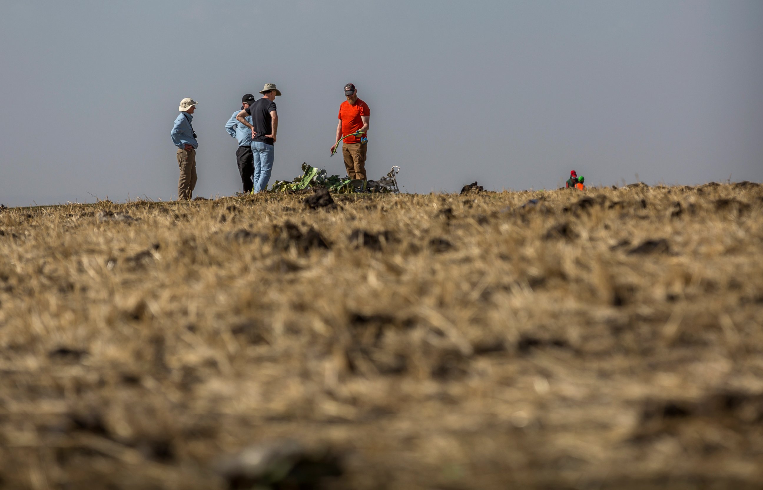 Foreign investigators examine wreckage at the scene where the Ethiopian Airlines Boeing 737 Max 8 crashed shortly after takeoff on Sunday killing all 157 on board, near Bishoftu, or Debre Zeit, south of Addis Ababa, in Ethiopia Tuesday, March 12, 201