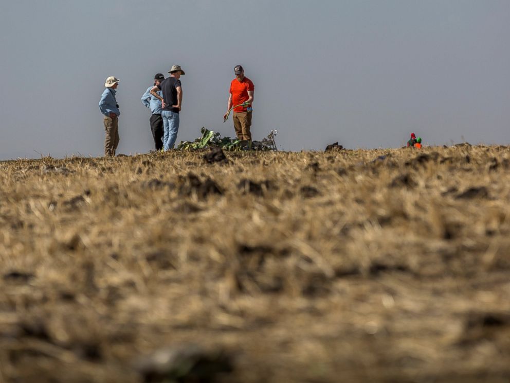 Foreign investigators examine wreckage at the scene where the Ethiopian Airlines Boeing 737 Max 8 crashed shortly after takeoff on Sunday killing all 157 on board, near Bishoftu, or Debre Zeit, south of Addis Ababa, in Ethiopia Tuesday, March 12, 201