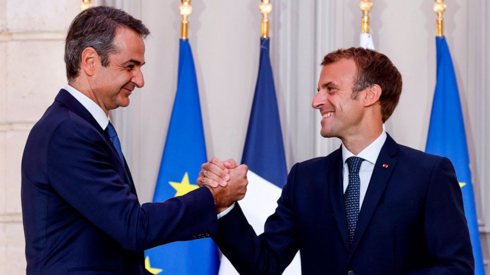 Greek Prime Minister Kyriakos Mitsotakis, left, and French President Emmanuel Macron shake hands after the signing of a new defense deal at The Elysee Palace Tuesday, Sept. 28, 2021 in Paris. France and Greece announced on Tuesday a major, multibilli