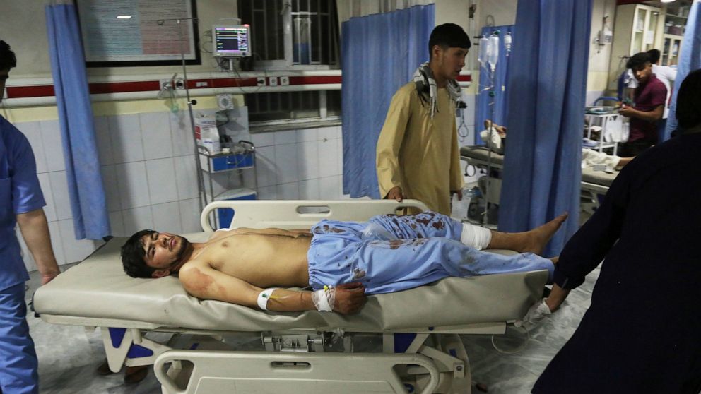 A wounded man is brought into a hospital after an explosion at wedding hall in Kabul, Afghanistan, Sunday, Aug. 18, 2019. An explosion ripped through a wedding hall on a busy Saturday night in Afghanistan's capital and dozens of people were killed or