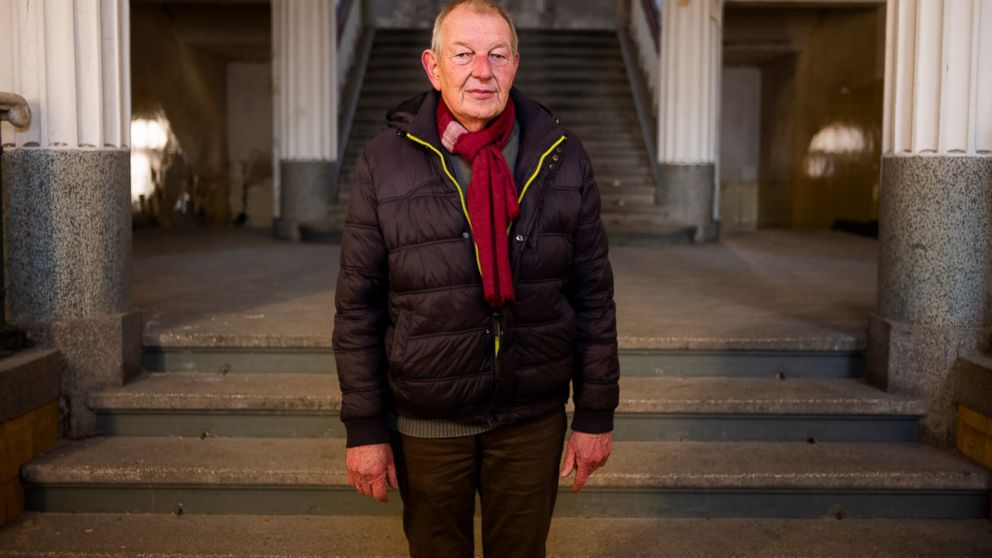 In this Tuesday, Feb. 22, 2019 photo guide Werner Borchert pose for a portrait in the main entrance of the abandoned "Haus der Offiziere", the headquarters for the Soviets' military high command in former East Germany at the Wuensdorf neighborhood of