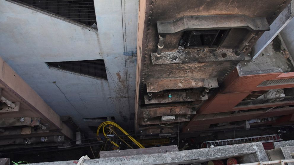 The walls of a building stand blackened after it caught fire in New Delhi, India, Sunday, Dec. 8, 2019. Dozens of people died on Sunday in a devastating fire at a building in a crowded grains market area in central New Delhi, police said. Firefighter