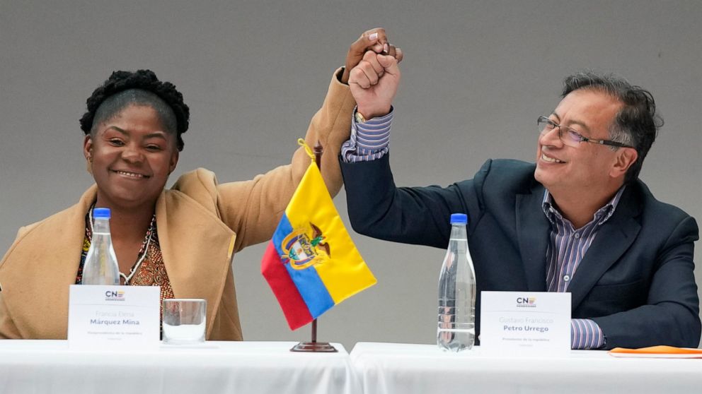 Colombian President-elect Gustavo Petro, right, and running mate Francia Marquez, join hands during a ceremony that certifies their election victory, in Bogota, Colombia, Thursday, June 23, 2022. (AP Photo/Fernando Vergara)
