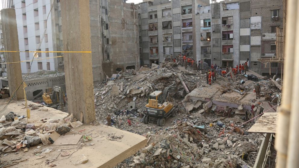 Pakistani troops, rescue workers and volunteers look for survivors amid the rubble of a collapsed building in Karachi, Pakistan, Monday, June 8, 2020. The multi-story residential building that was being expanded collapsed in a congested area of Karac