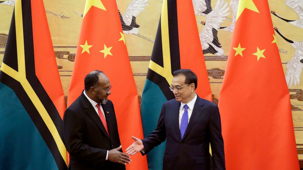FILE - Vanuatu Prime Minister Charlot Salwai, left, and Chinese Premier Li Keqiang, right, shake hands at a signing ceremony at the Great Hall of the People in Beijing, China Monday, May 27, 2019. China wants 10 small Pacific nations to endorse a swe