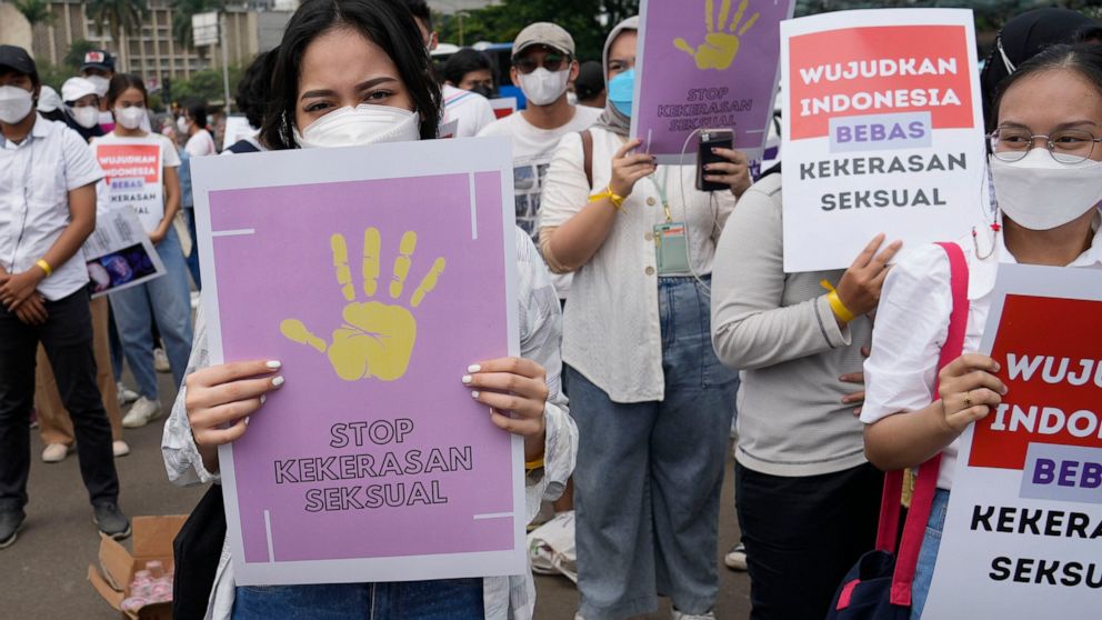 Activists hold posters reading "stop sexual violence" and "free Indonesia from sexual violence", during a rally commemorating the International Women's Day in Jakarta, Indonesia, Tuesday, March 8, 2022. Indonesia's parliament Tuesday, April 12, 2022,