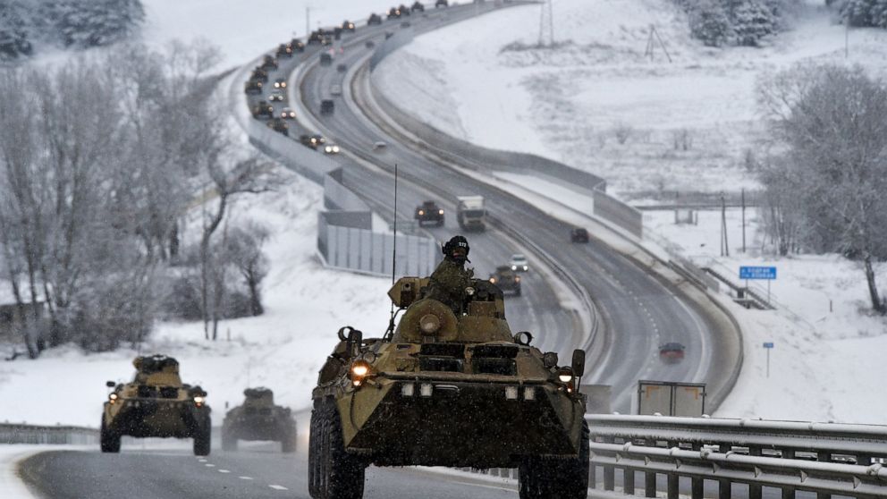 A convoy of Russian armored vehicles moves along a highway in Crimea, Tuesday, Jan. 18, 2022. Russia has concentrated an estimated 100,000 troops with tanks and other heavy weapons near Ukraine in what the West fears could be a prelude to an invasion