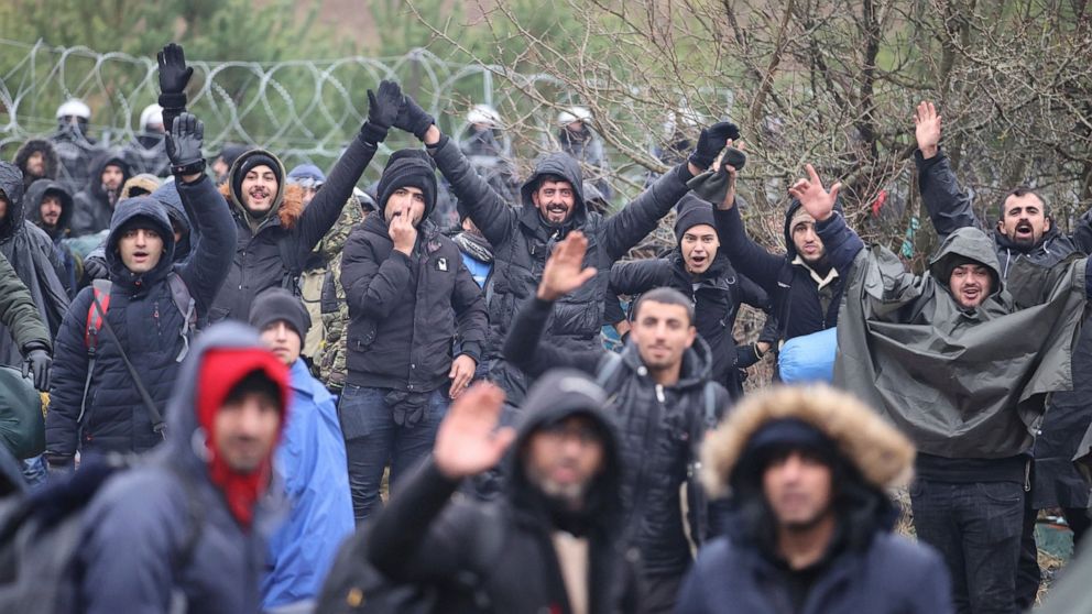 Migrants from the Middle East and elsewhere gather at the Belarus-Poland border near Grodno, Belarus, Monday, Nov. 8, 2021. Poland increased security at its border with Belarus, on the European Union's eastern border, after a large group of migrants 