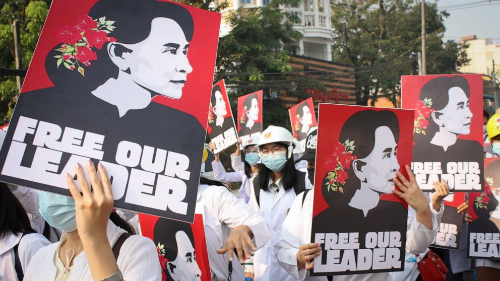 FILE - Medicals students display images of deposed Myanmar leader Aung San Suu Kyi during a street march in Yangon, Myanmar, on Feb. 28, 2021. A Myanmar court convicted Suu Kyi in more corruption cases Monday, Aug. 15, 2022, adding six years to priso