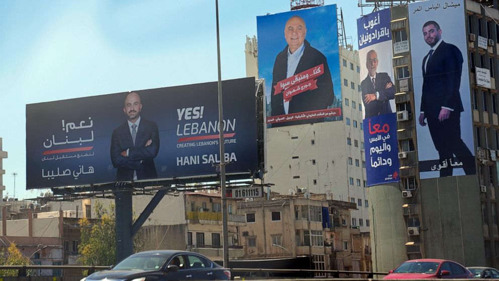 FILE - Campaign posters for the upcoming parliamentary candidates elections are displayed in Beirut, Lebanon on April 14, 2022. Thousands of Lebanese living in nearly 50 countries began early voting Sunday, May 8, 2022 in the country’s closely watche