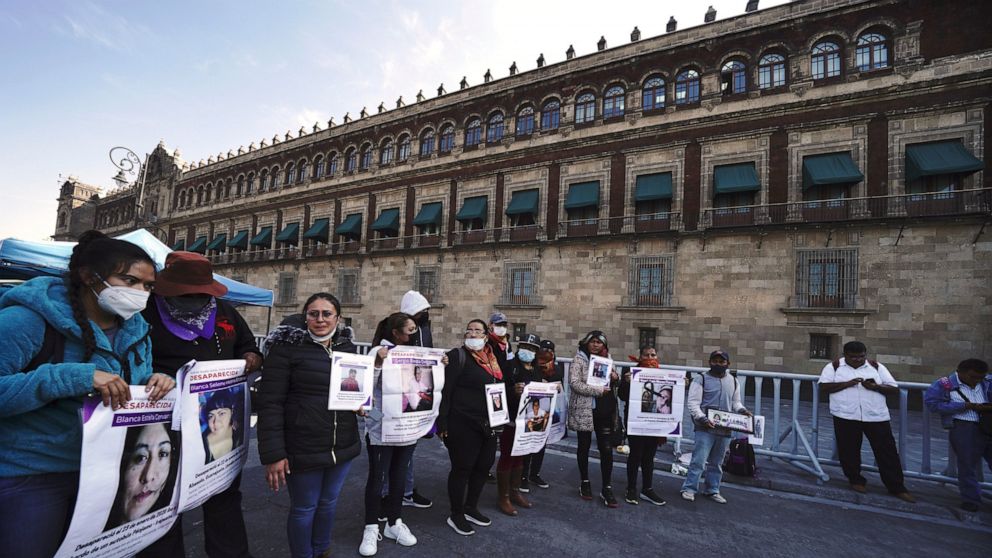People who have family members who have gone missing gather outside the National Palace to demand answers from the government about the disappeared in Mexico City, Monday, Dec. 13, 2021. (AP Photo/Marco Ugarte)