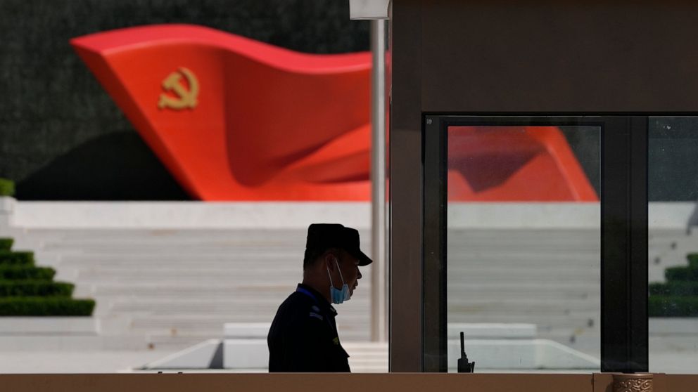 FILE - A security guard stands near a sculpture of the Chinese Communist Party flag at the Museum of the Communist Party of China on May 26, 2022, in Beijing. China said it was conducting military exercises Saturday, July 30, off its coast opposite T