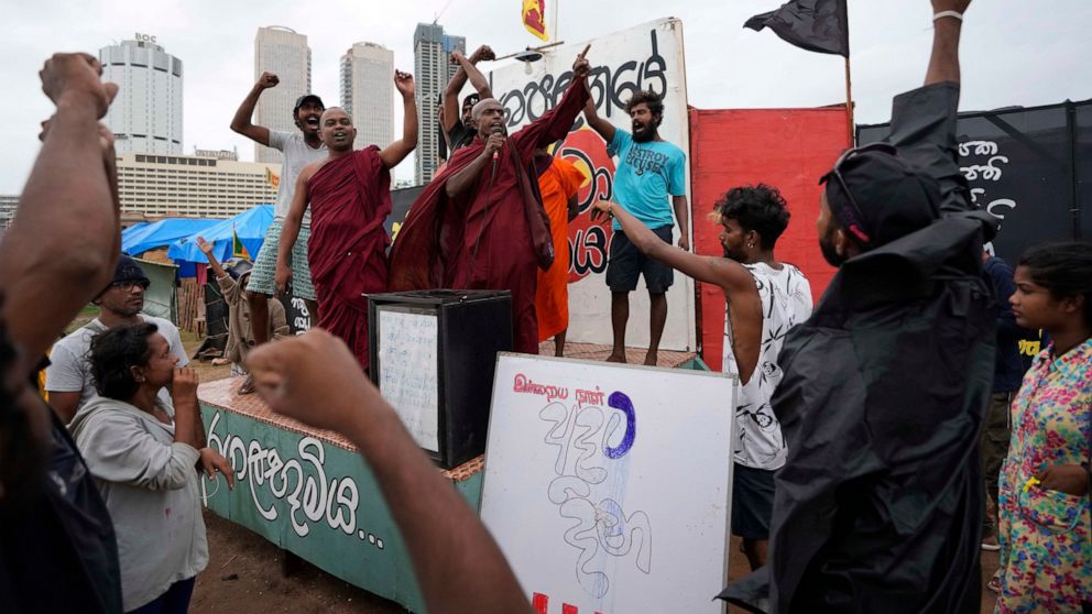Protesters shout against president Ranil Wickremesinghe's government in Colombo, Sri Lanka, Wednesday, Aug. 3, 2022. Sri Lanka's new president says his government is preparing a national policy roadmap for the next 25 years that aims to cut public de