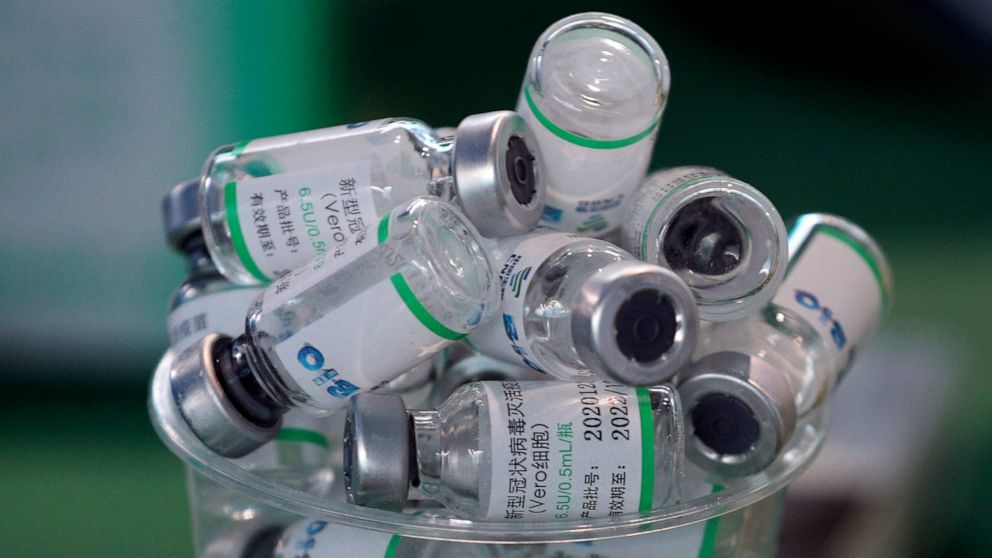 Empty vials of China's Sinopharm vaccine sit in a cup during a priority COVID-19 vaccination campaign of health workers at a public hospital in Lima, Peru, Wednesday, Feb. 10, 2021. Peru received its first shipment of COVID-19 vaccines on Sunday nigh