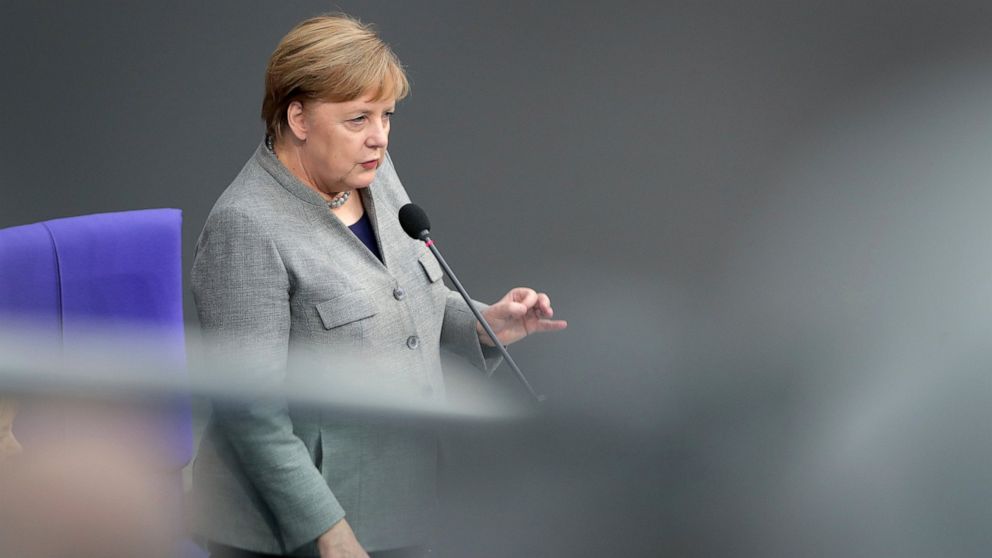 German Chancellor Angela Merkel takes questions as part of a meeting of the German parliament, Bundestag, at the Reichstag building in Berlin, Germany, Wednesday, Dec. 18, 2019. (AP Photo/Michael Sohn)