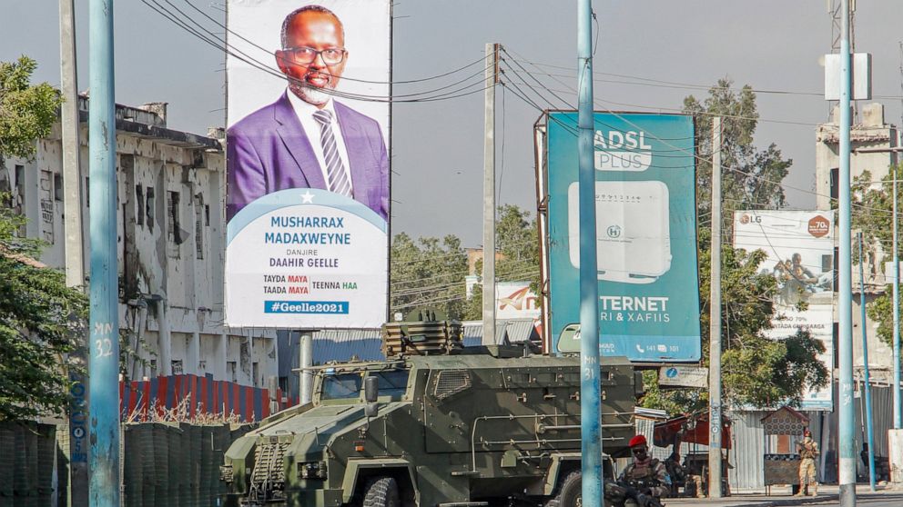 Security forces block a street with an armored personnel carrier during protests against the government and the delay of the country's election in the capital Mogadishu, Somalia Friday, Feb. 19, 2021. Security forces in Somalia's capital fired on hun