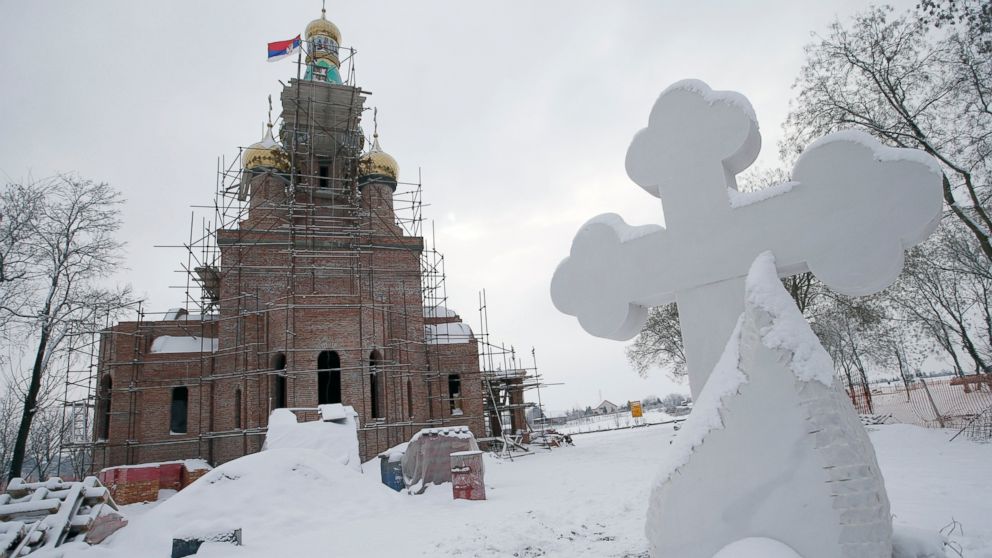 In this photo taken Friday, Jan. 11, 2019, the new church under construction designed in the Russian style in the village Banstol in northwestern Serbia. Topped with Russia-style green and gold onion-shaped domes, the church in this tiny village in northwestern Serbia is still under construction but it has already been dubbed ''Putin's church.'' (AP Photo/Darko Vojinovic)