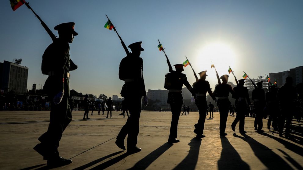 FILE - Ethiopian military parade with national flags attached to their rifles at a rally organized by local authorities to show support for the Ethiopian National Defense Force (ENDF), at Meskel square in downtown Addis Ababa, Ethiopia on Nov. 7, 202