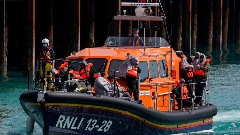 A group of people thought to be migrants are brought in to Dover, Kent, England, by the RNLI, following a small boat incident in the Channel, Thursday April 14, 2022. Britain's Conservative government has struck a deal with Rwanda to send some asylum