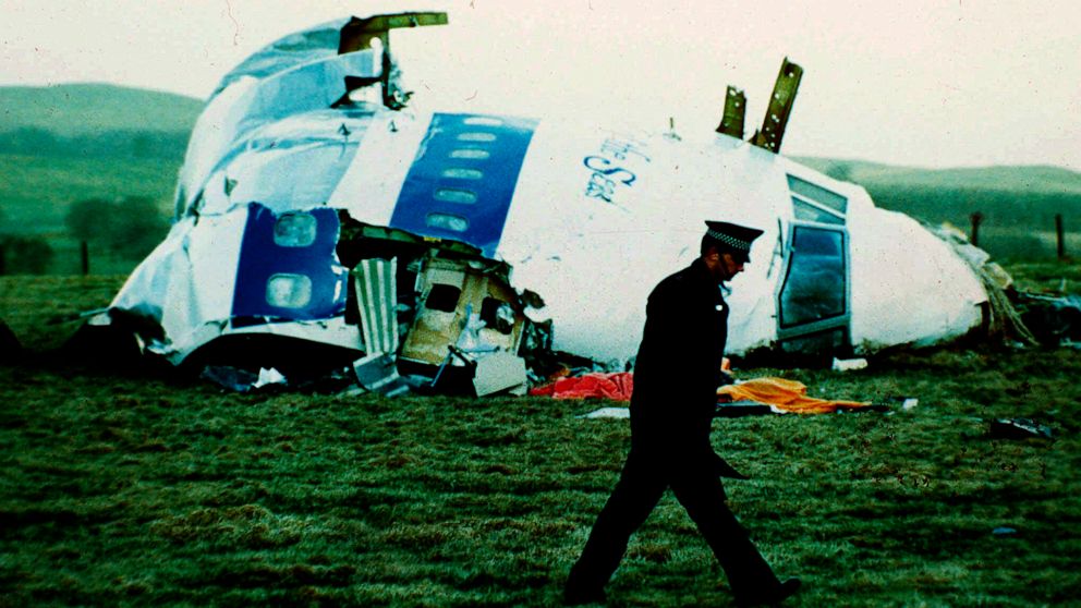 FILE - A police officer walks by the nose of Pan Am flight 103 in a field near the town of Lockerbie, Scotland where it lay after a bomb aboard exploded, killing a total of 270 people, Wednesday, Dec. 21, 1988. Authorities in Scotland on Sunday, Dec.