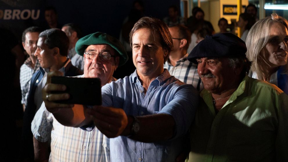 Uruguay’s President-elect Luis Lacalle Pou takes a selfie with supporters at the Rural Association where gauchos are gathering ahead of their official participation in the upcoming inaugural festivities, in Montevideo, Uruguay, Saturday, Feb. 29, 202