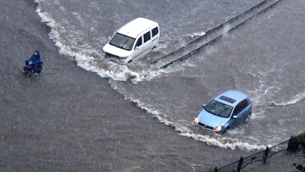 China blasts dam to divert floods that killed at least 12