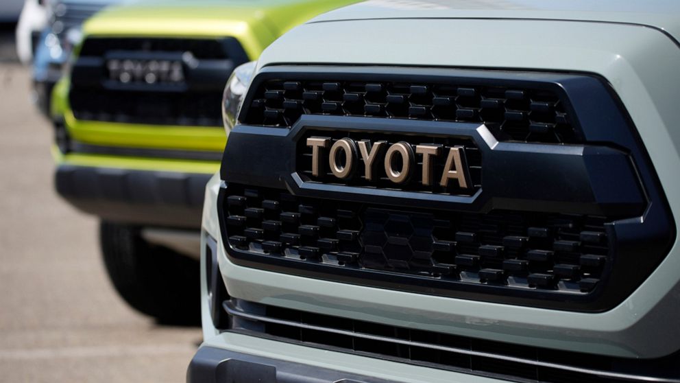 FILE - The company logo highlights the grille of a 2021 Tacoma pickup truck on display in the Toyota exhibit at the Denver auto show Friday, Sept. 17, 2021, at Elitch's Gardens in downtown Denver. Japan’s top automaker Toyota reported Thursday, Nov. 
