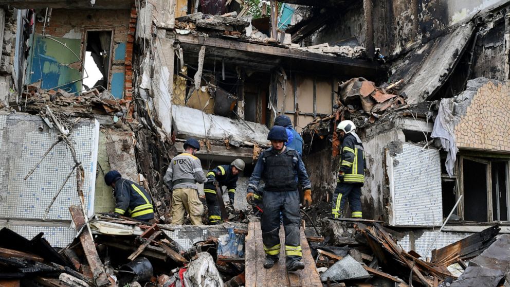 Rescuers work at a site of an apartment building destroyed by Russian shelling in Bakhmut, Donetsk region, Ukraine, Wednesday, May 18, 2022. (AP Photo/Andriy Andriyenko)