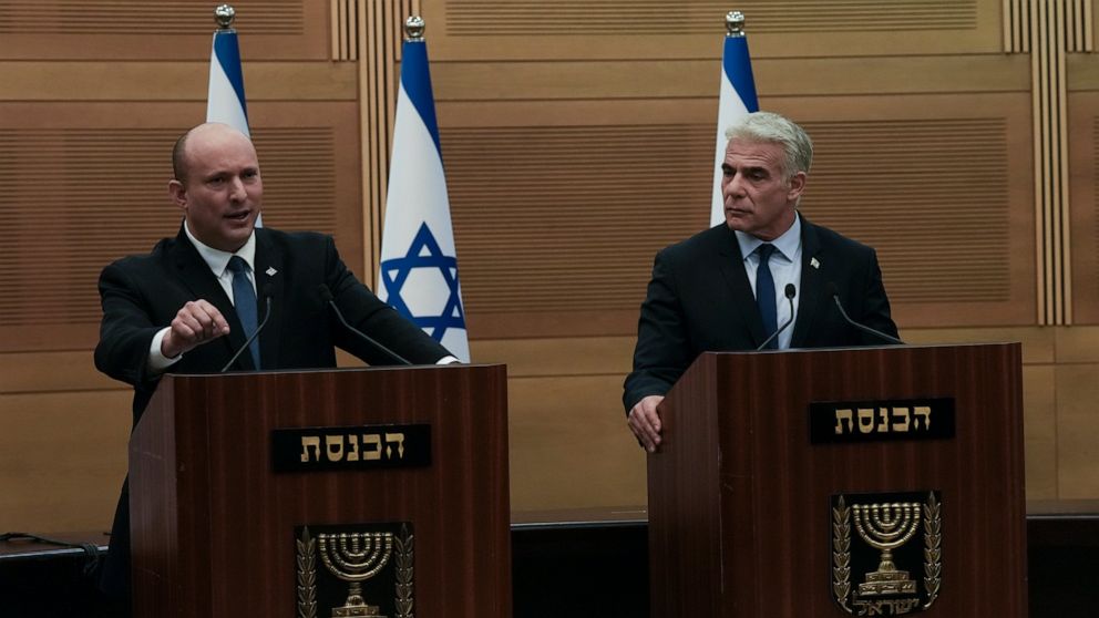 Israeli Prime Minister Naftali Bennett, left, speaks during a joint statement with Foreign Minister Yair Lapid, at the Knesset, Israel's parliament, in Jerusalem, Monday, June 20, 2022. Bennett's office announced Monday, that his weakened coalition w