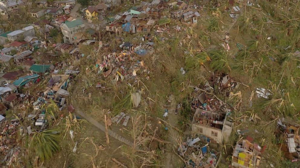 In this photo provided by the Philippine Navy, damaged houses and toppled trees lie in Dinagat Island, Surigao del Norte province, southern Philippines on Friday, Dec. 17, 2021. The governor of an island province in the central Philippines said dozen