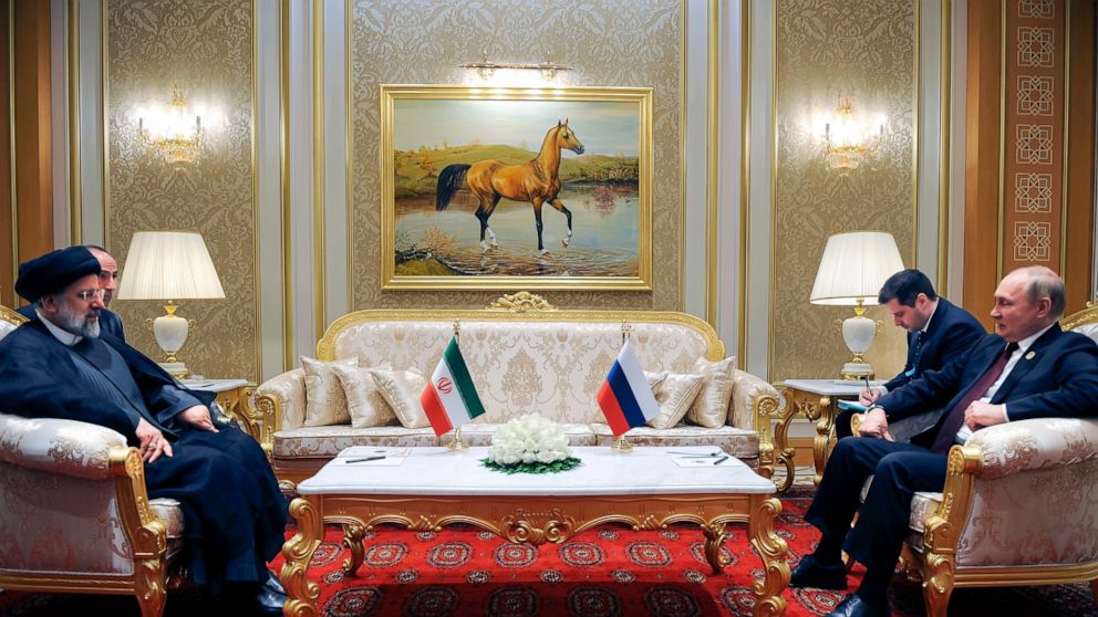 FILE - Russian President Vladimir Putin, right, speaks to Iran's President Ebrahim Raisi on the sideline of the summit of Caspian Sea littoral states in Ashgabat, Turkmenistan, Wednesday, June 29, 2022. (Mikhail Klimentyev, Sputnik, Kremlin Pool Phot