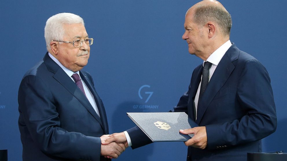 German Chancellor Olaf Scholz, right, and Mahmoud Abbas, President of the Palestinian Authority, shake hands after a press conference after their talks in Berlin, Germany, Tuesday, Aug.16, 2022. (Wolfgang Kumm/dpa via AP)