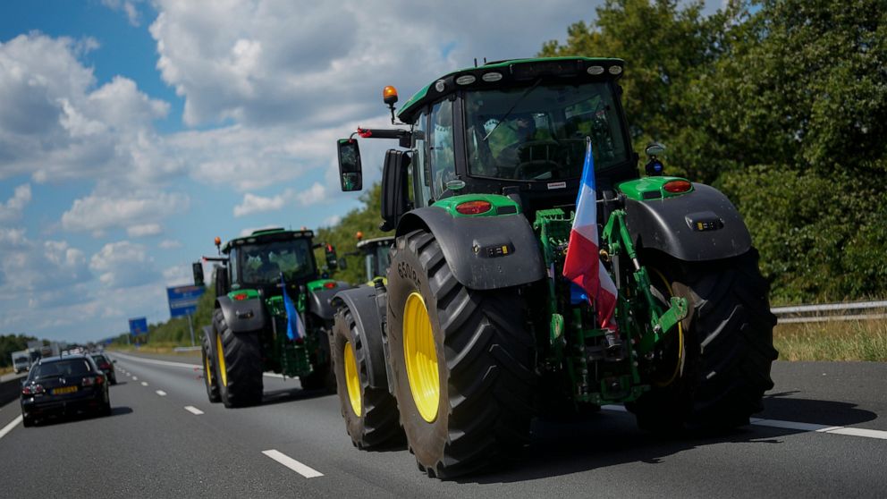 Demonstrating farmers slow down traffic on a motorway near Venlo, southern Netherlands, Monday, July 4, 2022. Dutch farmers angry at government plans to slash emissions used tractors and trucks Monday to blockade supermarket distribution centers, the