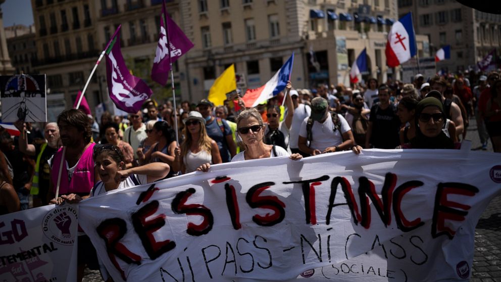 FILE - Protesters march during a demonstration to denounce a COVID-19 health pass needed to access restaurant, long-distance trains and other venues. in Marseille, southern France, Saturday, Aug. 14, 2021. The run-up to the April election comes in a 
