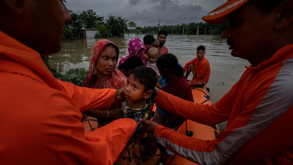 National Disaster Response Force (NDRF) personnel rescue flood-affected villagers in Korora village, west of Gauhati, India, Friday, June 17, 2022. (AP Photo/Anupam Nath)