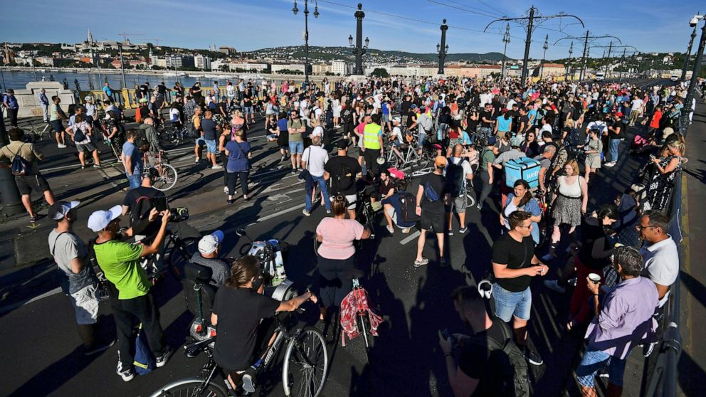 Demonstrators gather for an anti-government protest, in Budapest, Hungary, Monday, July 18, 2022. Anti-government demonstrators in Hungary blocked one of the capital's main thoroughfares during morning rush-hour traffic Monday, the latest in a series