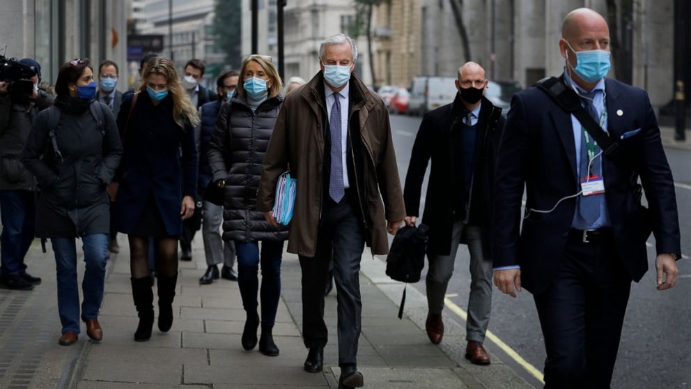 EU Chief Negotiator Michel Barnier, centre, with his team as he walks to a conference centre in Westminster in London, Sunday, Nov. 29, 2020. Teams from Britain and the European Union are continuing face-to-face talks on a post-Brexit trade deal in t