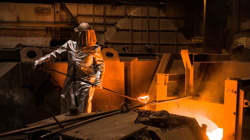 FILE -- An employee in protective clothing takes a sample from the furnace at the steel producer, Salzgitter AG, in Salzgitter, Germany, Thursday, March 22, 2018. Germany’s biggest industrial union has agreed with employers on a pay deal that will se