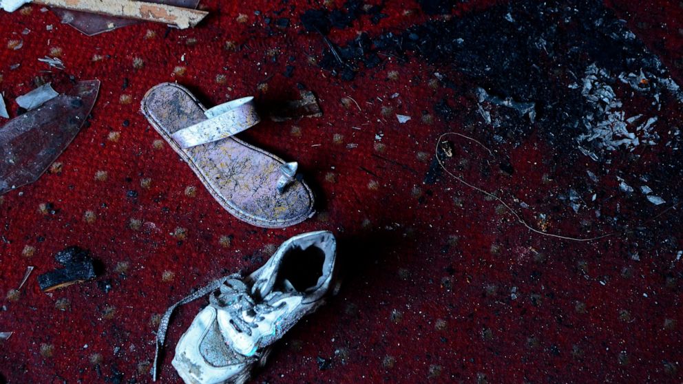 Abandoned shoes remain at the site of a fire inside the Abu Sefein Coptic church that killed at least 40 people and injured some 14 others, in the densely populated neighborhood of Imbaba, Cairo Egypt, Sunday, Aug. 14, 2022. The church said the fire 