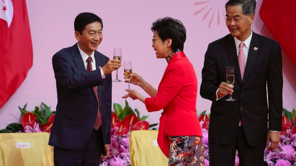 From right, former Hong Kong chief executive Leung Chun-ying, Hong Kong Chief Executive Carrie Lam and Luo Huining, Director of the Liaison Office of the Central People's Government in Hong Kong, toast at a reception, following the flag-raising cerem