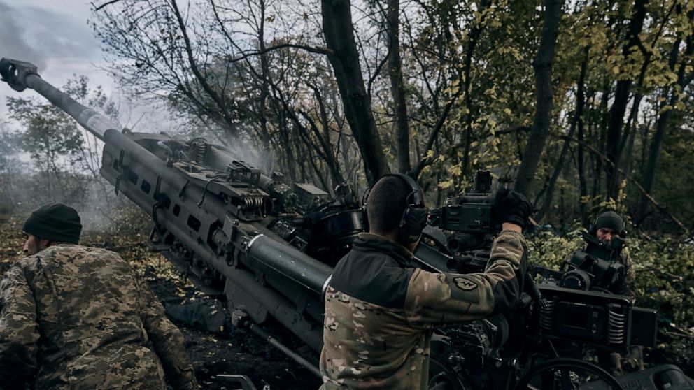 Ukrainian soldiers fire at Russian positions from a U.S.-supplied M777 howitzer in Ukraine's eastern Donetsk region Sunday, Oct. 23, 2022. (AP Photo/LIBKOS)
