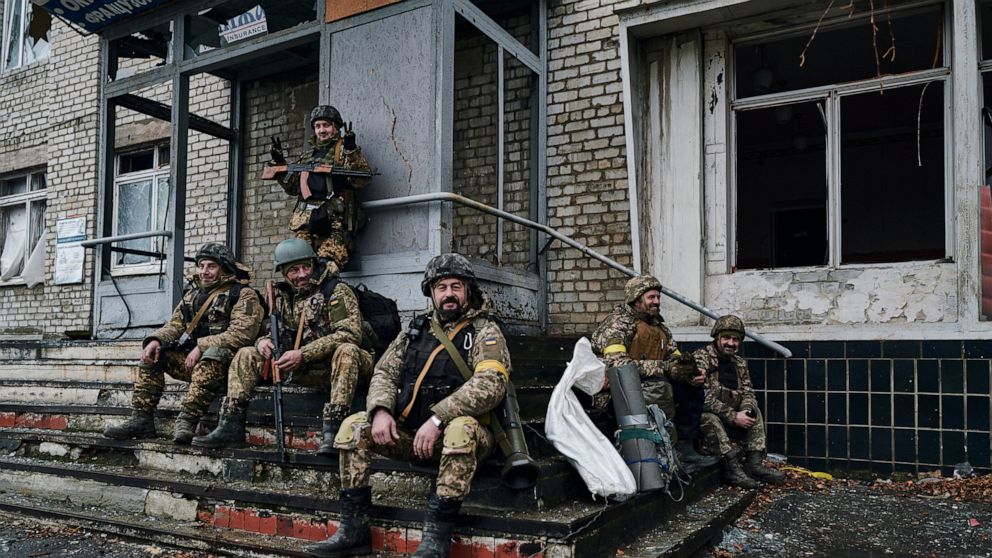 Ukrainian soldiers rest near their position in Bakhmut, Donetsk region, Ukraine, Saturday, Dec. 17, 2022. (AP Photo/LIBKOS)
