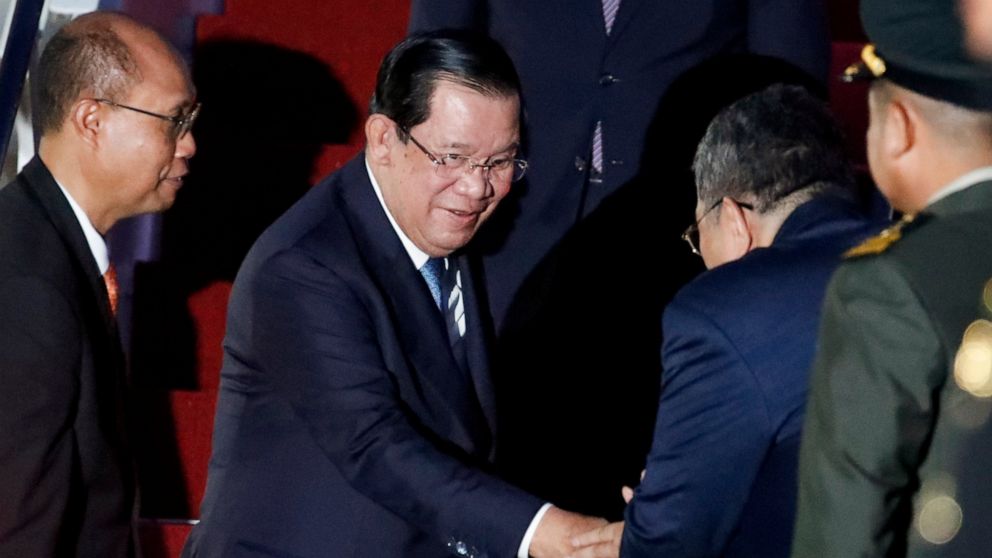 Cambodia's Prime Minister Hun Sen, center, arrives at Ngurah Rai International Airport ahead of the G20 Summit in Bali, Indonesia on Nov. 14, 2022. Hun Sen tests positive for COVID-19 at G-20, days after hosting world leaders at summit in Phnom Penh.