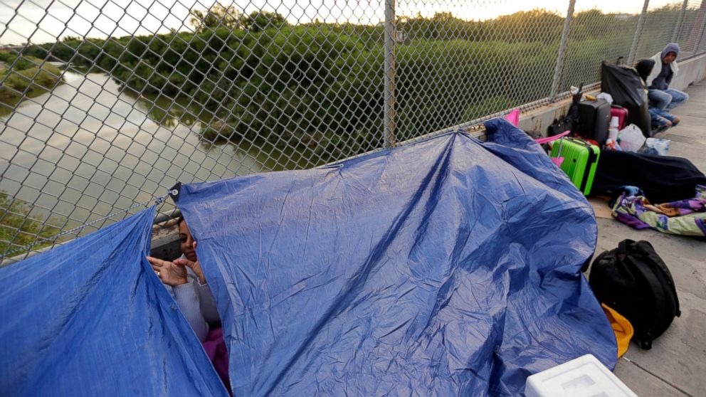 Maidelen Gonzales, an immigrant from Honduras seeking asylum in the United States, waits under a tarp on the Brownsville and Matamoros International Bridge, Friday, Nov. 2, 2018, in Matamoros, Mexico.