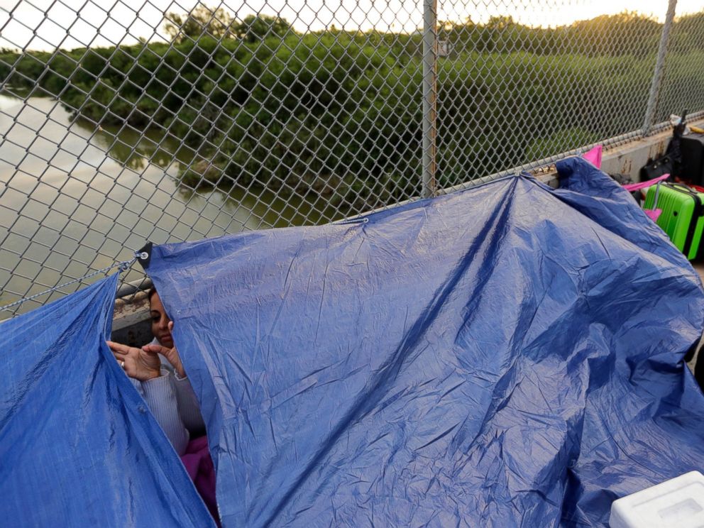 Maidelen Gonzales, an immigrant from Honduras seeking asylum in the United States, waits under a tarp on the Brownsville and Matamoros International Bridge, Friday, Nov. 2, 2018, in Matamoros, Mexico.