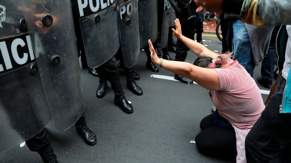 Police block supporters of former President Martín Vizcarra who protest near Congress where lawmakers voted the previous night to remove Vizcarra from office in Lima, Peru, Tuesday, Nov. 10, 2020. Congress voted to oust Vizcarra over his handling of 