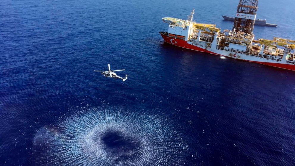 In this Tuesday, July 9, 2019 photo, a helicopter flies near Turkey's drilling ship, 'Fatih' dispatched towards the eastern Mediterranean, near Cyprus. Turkish officials say the drillships Fatih and Yavuz will drill for gas, which has prompted protes